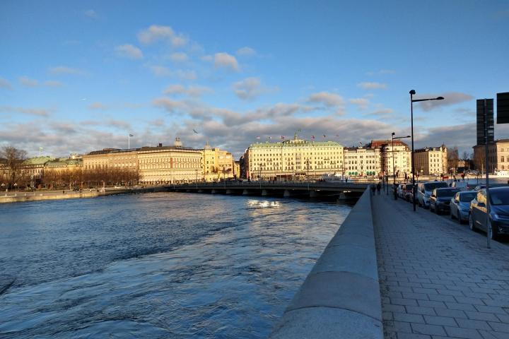 a body of water with a city in the background