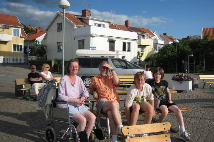 a group of people sitting in front of a building