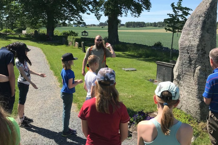 a group of people that are standing in the grass