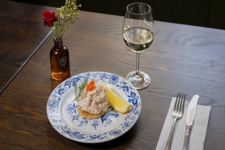 a plate of food and a glass of wine